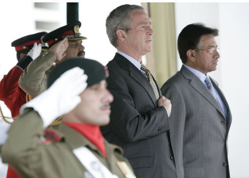 President George W. Bush and Pakistan President Pervez Musharraf stand together during President Bush's official welcome to Aiwan-e-Sadr in Islamabad, Pakistan, Saturday, March 4, 2006. White House photo by Eric Draper