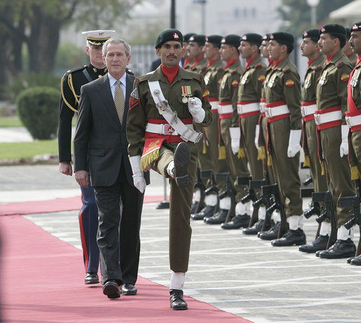 President George W. Bush is escorted by an honor guard as he reviews Pakistan troops at his official welcome to Aiwan-e-Sadr in Islamabad, Pakistan, Saturday, March 4, 2006. White House photo by Eric Draper