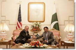 President George W. Bush is welcomed by Pakistan President Pervez Musharraf to Aiwan-e-Sadr in Islamabad, Pakistan, Saturday, March 4, 2006. White House photo by Eric Draper