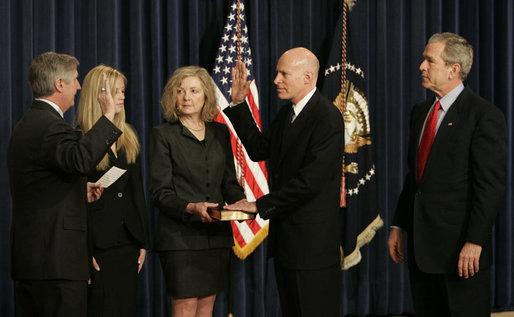 President George W. Bush joins Victoria Lazear and her daughter Julie as Chief of Staff Andy Card swears in Eddie Lazear Monday, March 6, 2006, as Chairman of the Council of Economic Advisers during a ceremony in the Eisenhower Executive Office Building. White House photo by Kimberlee Hewitt