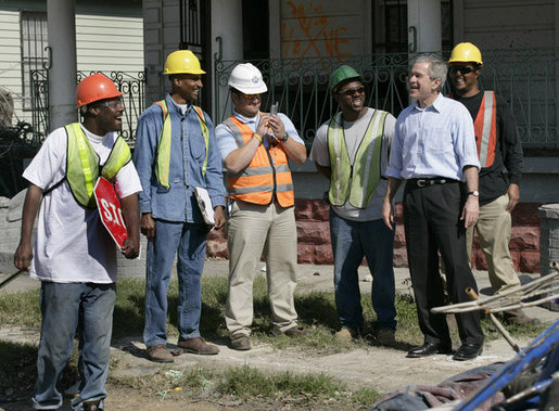 President George W. Bush talks with workers cleaning up the hurricane ravaged neighborhood of the lower 9th Ward of New Orleans, Wednesday, March 8, 2006, during a tour of New Orleans neighborhoods. White House photo by Eric Draper