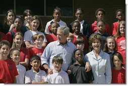 President George W. Bush and Laura Bush pose with students at the College Park Elementary School in Gautier, Miss., Wednesday, March 8, 2006, where Mrs. Bush announced the establishment of The Gulf Coast School Library Recovery Initiative, to help Gulf Coast schools that were damaged by the hurricanes rebuild their book and material collections. The initiative was established by the Laura Bush Foundation for American Libraries.  White House photo by Eric Draper