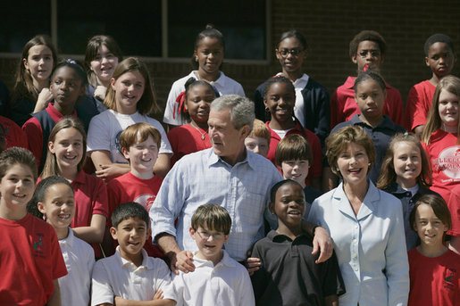 President George W. Bush and Laura Bush pose with students at the College Park Elementary School in Gautier, Miss., Wednesday, March 8, 2006, where Mrs. Bush announced the establishment of The Gulf Coast School Library Recovery Initiative, to help Gulf Coast schools that were damaged by the hurricanes rebuild their book and material collections. The initiative was established by the Laura Bush Foundation for American Libraries. White House photo by Eric Draper
