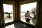 President George W. Bush looks over building plans with homeowner Jerry Akins at his home Wednesday, March 8, 2006 in Gautier, Miss., on the site where the Akins family is rebuilding their home destroyed by Hurricane Katrina. White House photo by Eric Draper