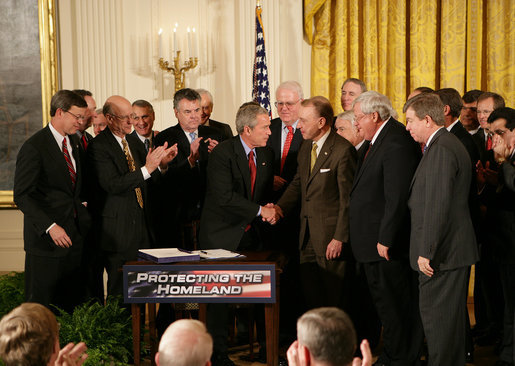 President George W. Bush shakes hands with U.S. Senator Arlen Specter, R. Pa., after signing H.R. 3199, USA PATRIOT Improvement and Reauthorization Act of 2005, Thursday, March 9, 2006 in the East Room of the White House. White House photo by Kimberlee Hewitt