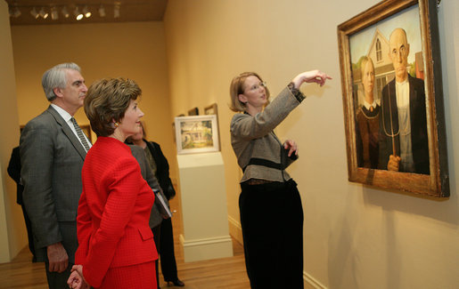 Mrs. Laura Bush listens Thursday evening, March 9, 2006 to Jane Milosch, curator of the Smithsonian American Art Museum's Renwick Gallery in Washington, as Mrs. Bush is shown the famous Grant Wood painting "American Gothic," during a tour of the Renwick Gallery exhibit, "Grant Wood's Studio: Birthplace of American Gothic," scheduled to open Friday, March 10, 2006. Mrs. Bush is accompanied on the tour by Ned. L. Rifkin, under secretary of art at the Smithsonian Institution. White House photo by Shealah Craighead