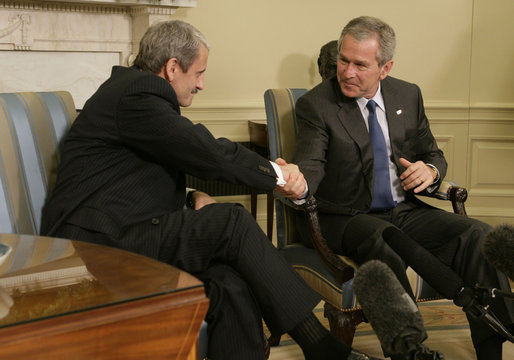 President George W. Bush and Prime Minister Mikulas Dzurinda of Slovakia, exchange handshakes during remarks in the Oval Office of the White House Monday, March 13, 2006. President Bush thanked the Prime Minister for his contributions to helping the young democracies in Afghanistan and Iraq succeed. White House photo by Paul Morse