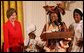 Mrs. Laura Bush reacts to remarks from Aunt Manyongo "Kunene" Mosima Tantoh, a member of the Mothers to Mothers-To-Be organization of South Africa, Monday, March 13, 2006 in the East Room at the White House. Mrs. Bush had earlier met with members of the group, who mentor and counsel mothers who come for prenatal care to clinics and find they are HIV-positive, on her visit to South Africa in July of 2005. Group member Gloria Ncanywa is seen at right. White House photo by Shealah Craighead