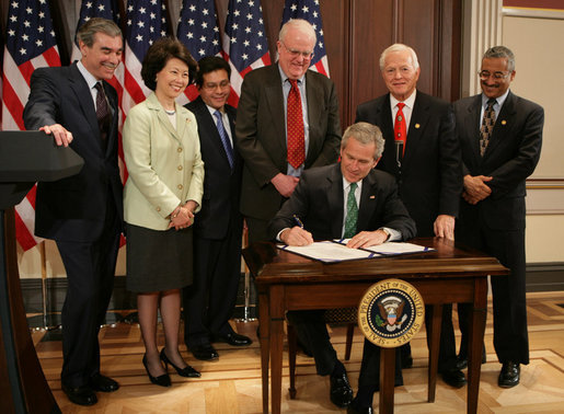 President George W. Bush signs the H.R. 32, the Stop Counterfeiting in Manufactured Goods Act, during ceremonies Thursday, March 16, 2006, in the Eisenhower Executive Office Building. Looking on are, from left: Secretary Carlos Gutierrez, Department of Commerce; Secretary Elaine Chao, Department of Labor; Attorney General Alberto Gonzales; U.S. Rep. Jim Sensenbrenner (R-Wis.); U.S. Rep.Joe Knollenberg (R-Mich.), and U.S. Rep. Bobby Scott (D-Va.). White House photo by Kimberlee Hewitt