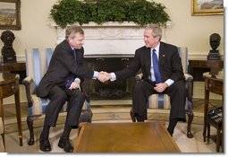 President George W. Bush welcomes NATO Secretary General Jaap de Hoop Scheffer to the Oval Office at the White House, Monday, March 20, 2006 in Washington.  White House photo by Kimberlee Hewitt