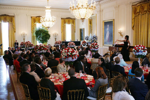 President George W. Bush and Mrs. Laura Bush join invited guests in listening to vocal star Denyce Graves at a White House social luncheon in honor of Liberia's President Ellen Johnson Sirleaf, Tuesday, March 21, 2006, at the White House. White House photo by Shealah Craighead