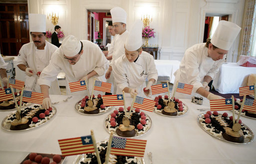 White House Executive Pastry Chef Thaddeus DuBois, center-background, supervises his staff, Tuesday, March 21, 2006, as they prepare the dessert trays for the social luncheon in honor of Liberia's President Ellen Johnson Sirleaf at the White House. White House photo by Paul Morse