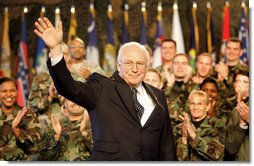 Vice President Dick Cheney waves in response to a warm welcome given by the troops and their families at a rally at Scott Air Base in Illinois, Tuesday, March 21, 2006.  White House photo by David Bohrer