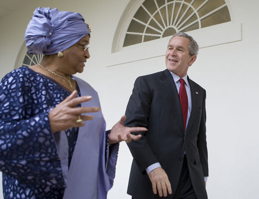 President George W. Bush and Liberia's President Ellen Johnson Sirleaf talk as they walk along the Colonnade from the Oval Office at the White House, Tuesday, March 21, 2006. White House photo by Eric Draper