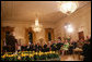 President George W. Bush and Mrs. Laura Bush join their invited guests in listening to Benjamin Franklin interpreter, Ralph Archbold of Philadelphia, Pa., Thursday evening, March 23, 2006 in the East Room of the White House, during a Social Dinner to honor the 300th birthday of Benjamin Franklin. White House photo by Shealah Craighead