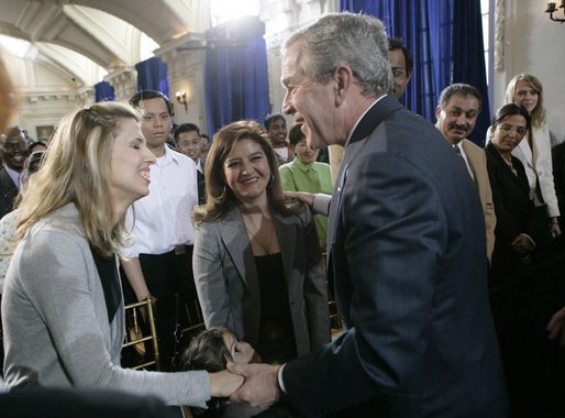 President George W. Bush congratulates newly sworn-in U.S. citizens Monday, March 27, 2006, following the Naturalization Ceremony at the Daughters of the American Revolution Administration Building in Washington. President Bush told the new U.S. citizens that each generation of immigrants brings a renewal to our national character and adds vitality to our culture. White House photo by Eric Draper