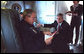 In this January 2002 file photo, President George W. Bush confers with Josh Bolten aboard Air Force One en route to Portland, Maine. President Bush announced Tuesday, March 28, 2006, that Director Bolten, of the Office of Management and Budget, will succeed Secretary Andrew Card as Chief of Staff. White House photo by Eric Draper