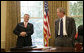 President George W. Bush shares a light moment with Chief of Staff Andrew Card in the Oval Office in this June 2005 file photo. Tuesday, March 28, 2006, the President announced Secretary Card's resignation effective in April. White House photo by Eric Draper