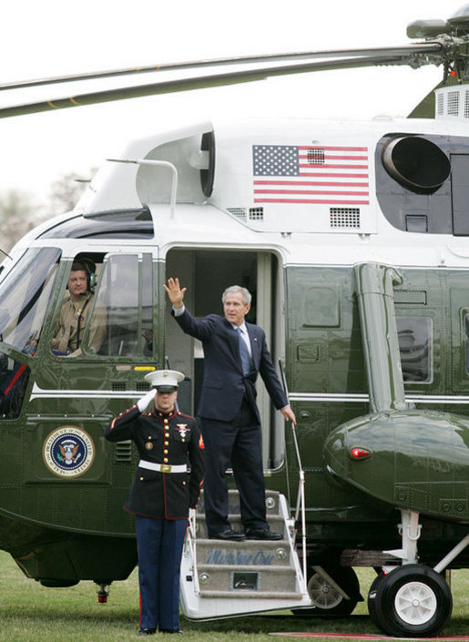 President George W. Bush waves from the steps of Marine One on the South Lawn of the White House, Wednesday, March 29, 2006, as he departs for a three-day summit with the leaders of Mexico and Canada in Cancun, Mexico. White House photo by Shealah Craighead