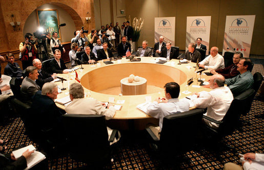 President George W. Bush, center, attends the Security and Prosperity Partnership meeting with Mexico's President Vicente Fox, right, and Canadian Prime Minister Stephen Harper, left, Friday, March 31, 2006 at the Fiesta Americana Condesa Cancun Hotel in Cancun, Mexico. White House photo by Eric Draper