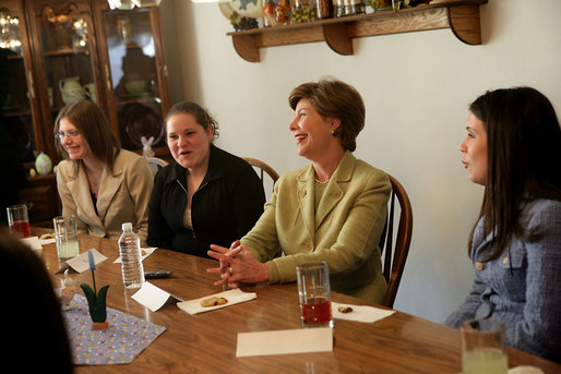 Mrs. Laura Bush shares in laughter with girls who are living in a family-style residential group home at Father Flanagan’s Girls & Boys Town in Omaha, NE, Monday, April 3, 2006. Girls and Boys Town was founded in 1917 to help troubled boys. Today there are more than 100 long-term, residential-care homes for trouble youths, featuring family-style living in the least restrictive environment. White House photo by Shealah Craighead