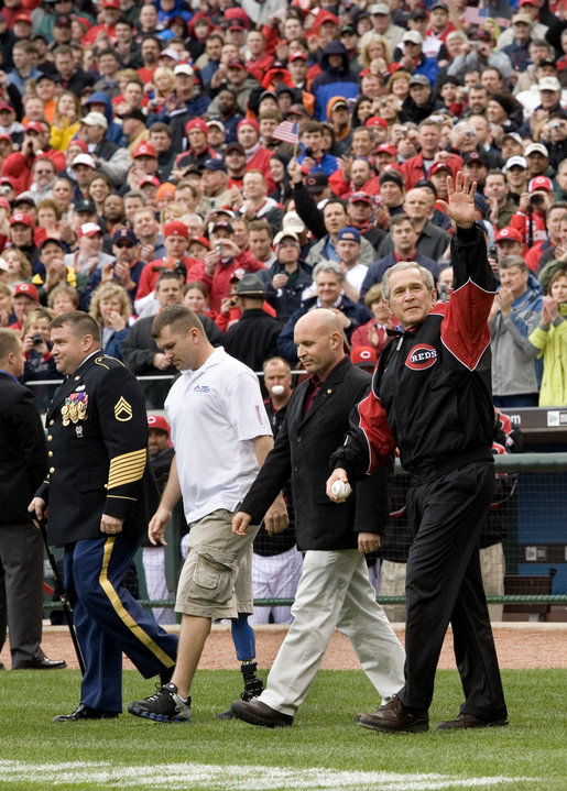U.S. Army Sgt. Paul Brondhaver, left, U.S. Army Sgt. Mike McNaughton, center, and John Prazynski accompany President George W. Bush to the pitchers mound during the opening game between the Cincinnati Reds and the Chicago Cubs in Cincinnati, Ohio, Monday, April 3, 2006. The three men are involved with Impact Player Partners, an Ohio-based group that provides support for wounded soldiers and their families. White House photo by Eric Draper