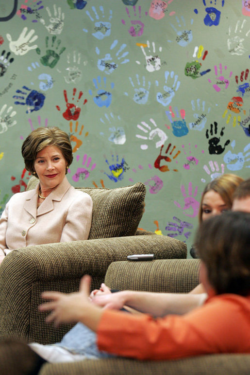 Mrs. Laura Bush listens to Kasey Harlin, Lead Therapist at Preferred Family Healthcare Adolescent Substance Abuse Rehabilitation Center in St. Louis, Mo., Tuesday, April 4, 2006, discuss the benefits that art therapy has had on her clients at the center. White House photo by Shealah Craighead