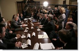 President George W. Bush answers a question from the press as he sits with members of the insurance, banking and business communities Tuesday, April 4, 2006, during a meeting at the White House on Health Care Initiatives.  White House photo by Paul Morse
