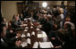 President George W. Bush answers a question from the press as he sits with members of the insurance, banking and business communities Tuesday, March 4, 2006, during a meeting at the White House on Health Care Initiatives.  White House photo by Paul Morse