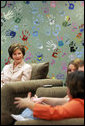 Mrs. Laura Bush listens to Kasey Harlin, Lead Therapist at Preferred Family Healthcare Adolescent Substance Abuse Rehabilitation Center in St. Louis, Mo., Tuesday, April 4, 2006, discuss the benefits that art therapy has had on her clients at the center. White House photo by Shealah Craighead