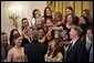 President George W. Bush reaches up to shake the hands with members of the University of Washington Women’s Volleyball Team Thursday, April 6, 2006, during a photo opportunity with the 2005 and 2006 NCAA Sports Champions. White House photo by Eric Draper