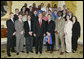 President George W. Bush stands with members of the University of Florida Men’s Basketball Team Thursday, April 6, 2006, during a photo opportunity with the 2005 and 2006 NCAA Sports Champions at the White House. White House photo by Eric Draper