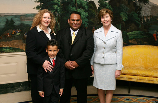 Mrs. Laura Bush poses for a photo with Sal Tinajero, his wife Jennifer and son Salvador, Thursday, April 6, 2006, in the Diplomatic Room at the White House. Mr. Tinajero, a high school teacher in Santa Ana, CA, is the recipient of Hispanic Magazine's Teacher of the Year award, which recognizes him as a single outstanding educator within the Hispanic community by means of motivating, inspiring and preparing his students for a promising future. White House photo by Shealah Craighead