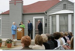 Mrs. Laura Bush, joined by former President George H.W. Bush, Mrs. Barbara Bush, and family friend, Joe O’Neill, speaks to the crowd on Tuesday, April 11, 2006, during a dedication and ribbon cutting ceremony for the opening of President George W. Bush’s Childhood Home in Midland, Texas.  White House photo by Shealah Craighead