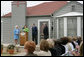 Mrs. Laura Bush, joined by former President George H.W. Bush, Mrs. Barbara Bush, and family friend, Joe O’Neill, speaks to the crowd on Tuesday, April 11, 2006, during a dedication and ribbon cutting ceremony for the opening of President George W. Bush’s Childhood Home in Midland, Texas. White House photo by Shealah Craighead