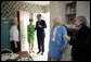 Gayle Dodson, Docent Coordinator, Left, and Dealey Herndon, Restoration/Historian greet Laura Bush, former President George H.W. Bush, and Mrs. Barbara Bush, Tuesday, April 11, 2006, at the beginning of their tour of George W. Bush Childhood Home in Midland, Texas. White House photo by Shealah Craighead