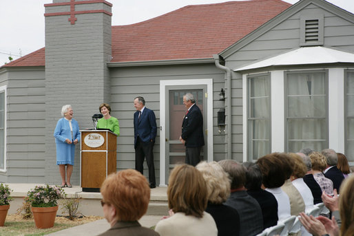 Mrs. Laura Bush, joined by former President George H.W. Bush, Mrs. Barbara Bush, and family friend, Joe O’Neill, speaks to the crowd on Tuesday, April 11, 2006, during a dedication and ribbon cutting ceremony for the opening of President George W. Bush’s Childhood Home in Midland, Texas. White House photo by Shealah Craighead