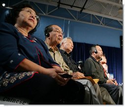 Audience members, some using headphones to hear a translation, listen to President George W. Bush talking to senior citizens at a Conversation on the Medicare Prescription Drug Benefit, Wednesday, April 12, 2006 at the Richard J. Ernst Community Center at Northern Virginia Community College in Annandale, Va. President Bush urged senior citizens to participate in the new Medicare drug benefit program to help reduce their drug costs.  White House photo by Kimberlee Hewitt