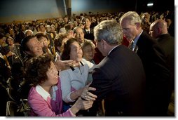 Audience members greet and hug President George W. Bush after his talk about the Medicare prescription drug benefits at the Richard J. Ernst Community Center at Northern Virginia Community College in Annandale, Va., Wednesday, April 12, 2006. President Bush urged senior citizens to participate in the new Medicare program to reduce their drug costs.  White House photo by Kimberlee Hewitt