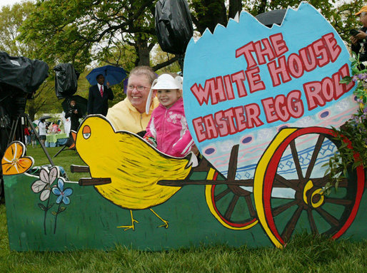 Guests pose for photos at a decorative display on the South Lawn of the White House during the 2006 White House Easter Egg Roll, Monday, April 17, 2006. The first White House Easter Egg Roll was held in 1878. White House Photo by Julie Kubal 