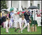 President George W. Bush is joined by Mrs. Laura Bush as he blows a whistle to start an Easter Egg Roll race on the South Lawn of the White House during the annual 2006 White House Easter Egg Roll, Monday, April 17, 2006. The first White House Easter Egg Roll was held in 1878. White House photo by Kimberlee Hewitt