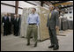 President George W. Bush tours the Europa Stone Distributors, Inc. facility in Sterling, Va., with company Vice President Adam Mahmud, Monday, April 17, 2006. Following the tour President Bush, who was joined by U.S. Treasury Secretary John Snow, U.S. Rep. Frank Wolf, R-Va., and White House Chief of Staff Josh Bolten, left, participated in a roundtable discussion on taxes and the economy. White House photo by Paul Morse