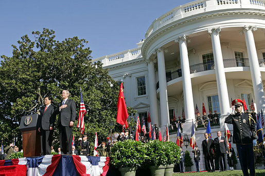 President George W. Bush and Chinese President Hu Jintao stand for the playing of the two countries' national anthems during the beginning of the South Lawn Arrival Ceremony Thursday, April 20, 2006. White House photo by Shealah Craighead