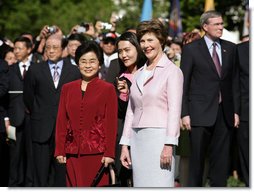 Mrs. Laura Bush stands with Liu Yongqing, the wife of Chinese President Hu Jintao, during the South Lawn Arrival Ceremony, Thursday, April 20, 2006. White House photo by Shealah Craighead