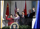 President George W. Bush, Chinese President Hu Jintao, Laura Bush and Hu's wife, Liu Yongqing, wave from the South Portico balcony after the South Lawn Arrival Ceremony at the White House, Thursday, April 20, 2006. White House photo by Shealah Craighead