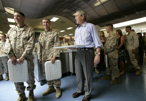 President George W. Bush stands in the chow line with Marines during his visit to Marine Corps Air Ground Combat Center in Twentynine Palms, California, Sunday, April 23, 2006. White House photo by Eric Draper