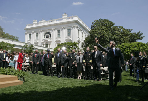 President George W. Bush waves to the United States Naval Academy football team after the presentation of the Commander-in-Chief Trophy in the Rose Lawn April 25, 2006. White House photo by Paul Morse