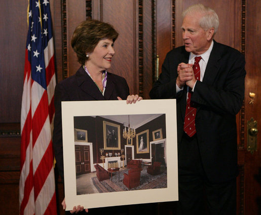 Mrs. Laura Bush is presented with a print by Dr. James Billington, the Librarian of Congress, showing an interior view of the White House as it looked in the early 1900s, Wednesday, April 26, 2006 during the James Madison Council Luncheon at the Library of Congress. White House photo by Kimberlee Hewitt