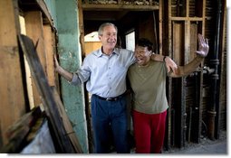 President George W. Bush shares a light moment with homeowner Ethel Williams during a visit to her hurricane damaged home in the 9th Ward of New Orleans, Louisiana, Thursday, April 27, 2006.  White House photo by Eric Draper