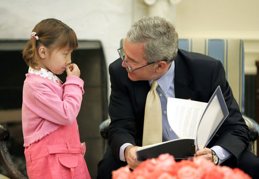 President George W. Bush spends a few moments with Kim Han-Mee in the Oval Office, the daughter of North Korean defectors, during a meeting April 28, 2006 with North Korean defectors and family members of Japanese citizens who were abducted by North Korea. White House photo by Paul Morse